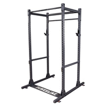 A sturdy black power rack with multiple adjustable levels, designed for weightlifting and strength training, featuring a solid base and numerous holes for customization.