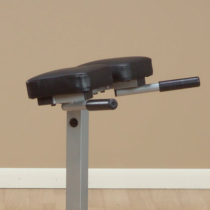 Close-up of a two-cushioned exercise bench with a black padded surface and a gray metallic frame, set against a neutral background.