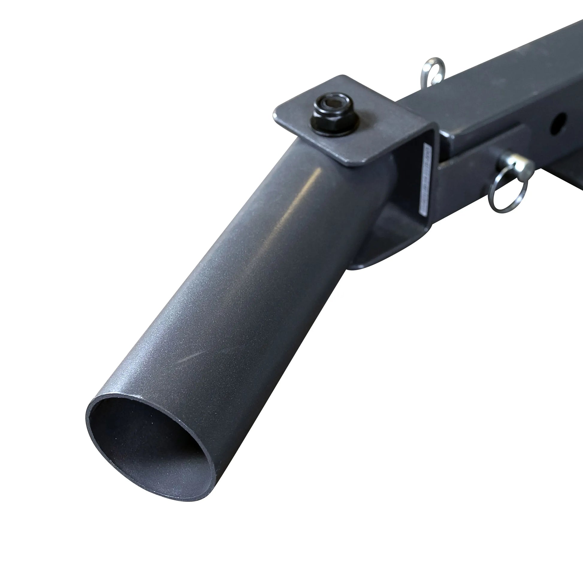 Close-up view of a metal pipe attachment with a circular opening, mounted on a metal frame, featuring a bolt and securing rings.
