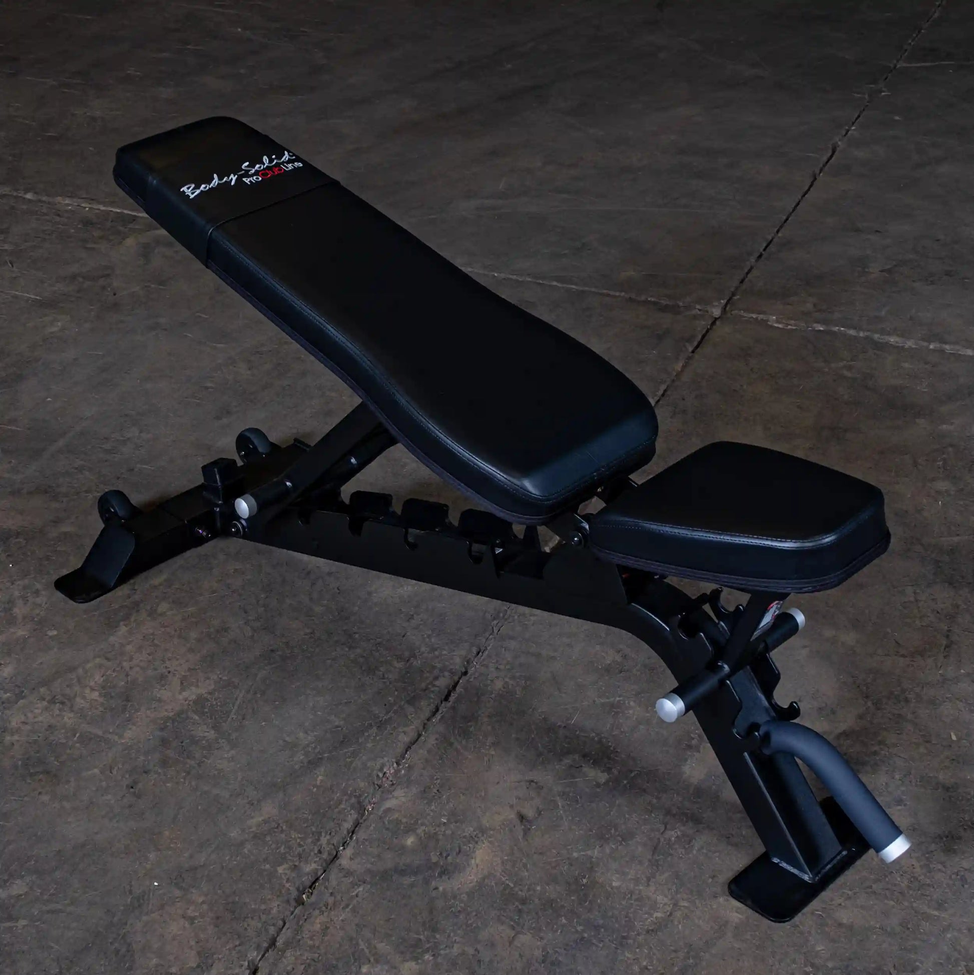 Body-Solid Pro ClubLine Adjustable Bench SFID325 positioned on a concrete floor, featuring a black padded seat and backrest.