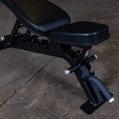 Close-up view of the Body-Solid Pro ClubLine Adjustable Bench SFID325, showcasing the padded seat and adjustable components on a concrete floor.