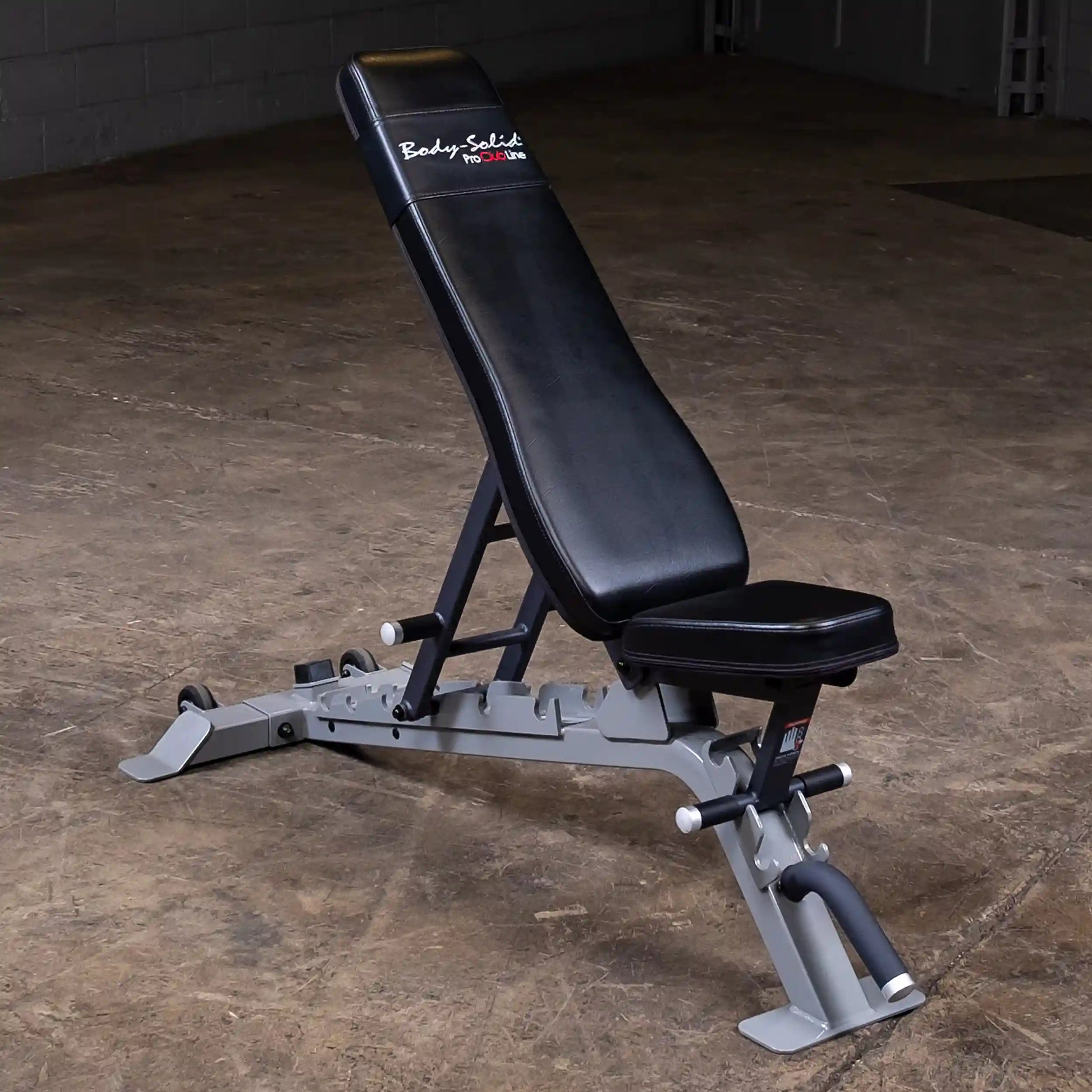 Body-Solid Pro ClubLine Adjustable Bench SFID325 positioned on a gym floor, featuring a black padded seat and backrest with a sturdy gray frame.