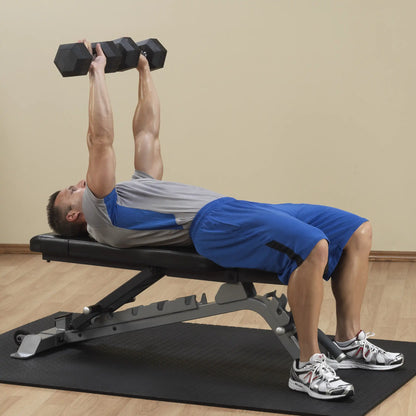 A person performing a strength training exercise with dumbbells while lying on the Body-Solid Pro ClubLine Adjustable Bench SFID325.