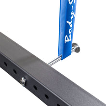 Close-up of the Body-Solid Pro ClubLine Band Pegs Attachment SPRBP mounted on a black exercise frame, showcasing the blue band peg and metal hardware.