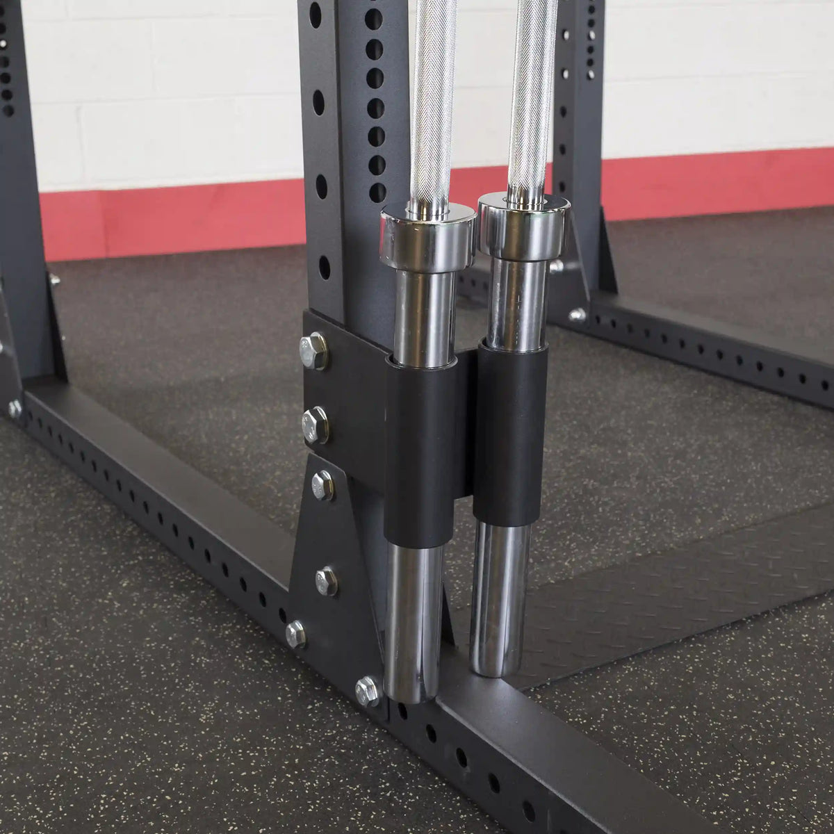 Close-up view of the Body-Solid Pro ClubLine Bar Holder Attachment SPRBHV, showcasing the attachment for securely holding Olympic bars on a weight rack.