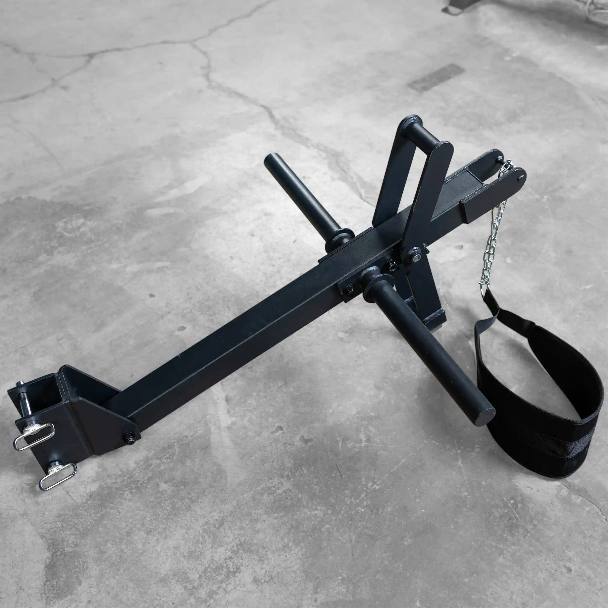 Body-Solid Pro ClubLine Belt Squat Attachment SPRBSA on a concrete surface, featuring handles and a padded strap for exercise use.