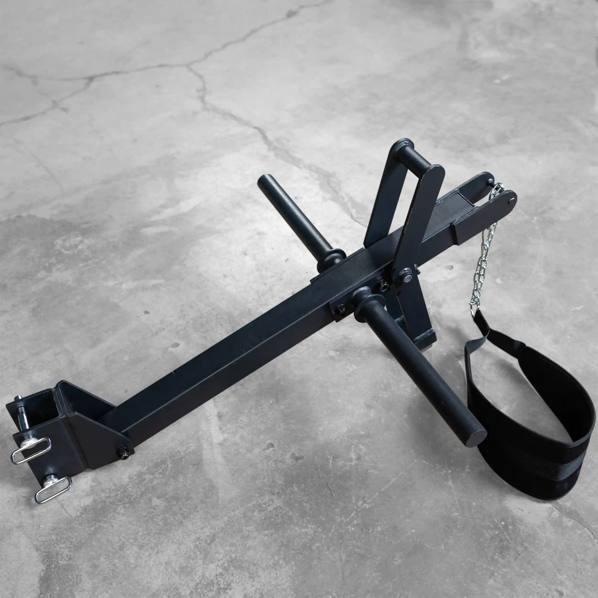 Black Body-Solid Pro ClubLine Belt Squat Attachment SPRBSA on a concrete floor, designed for lower body workouts, featuring adjustable handles and a belt strap.