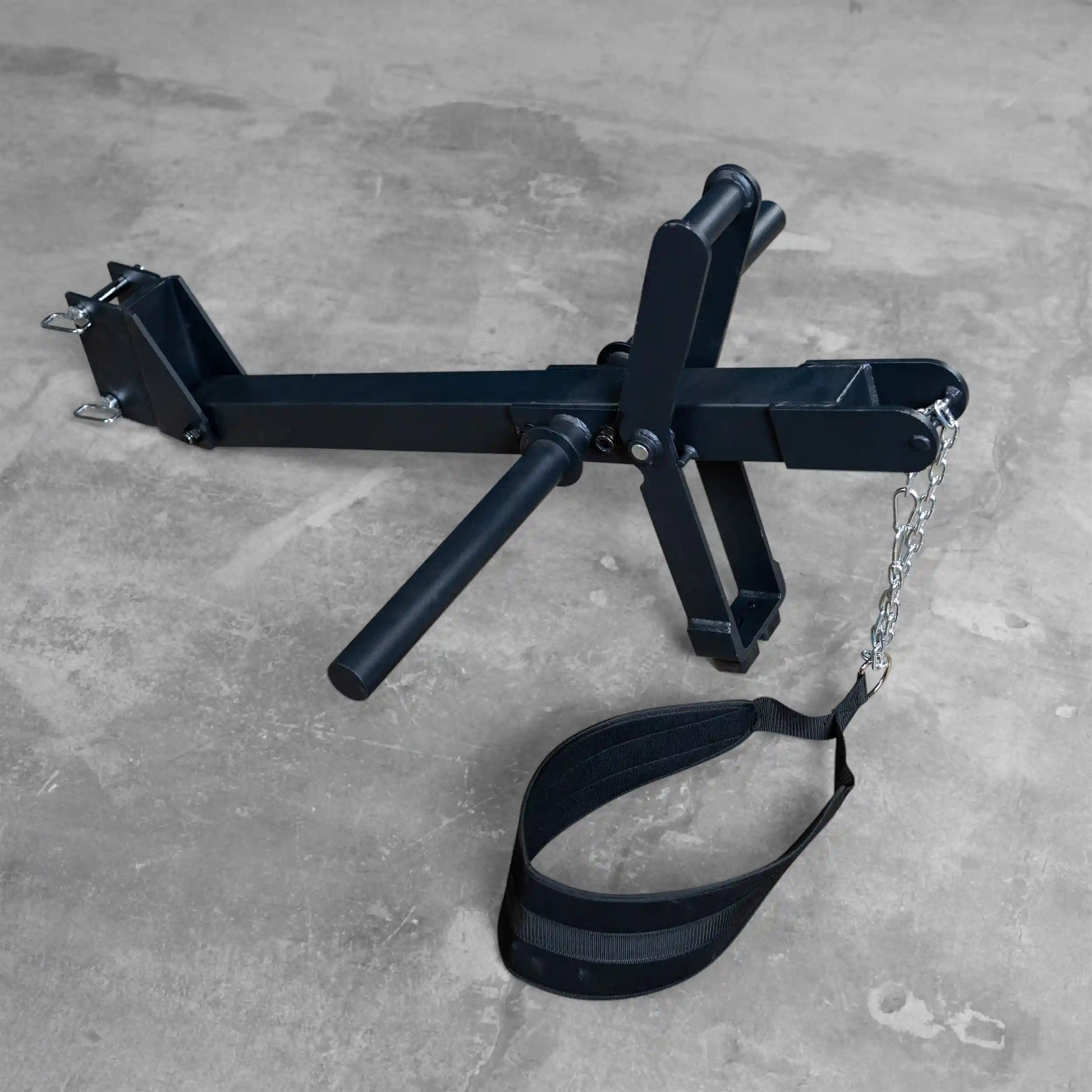 Body-Solid Pro ClubLine Belt Squat Attachment SPRBSA, featuring a sturdy metal frame with adjustable handles and a belt strap, placed on a concrete floor.