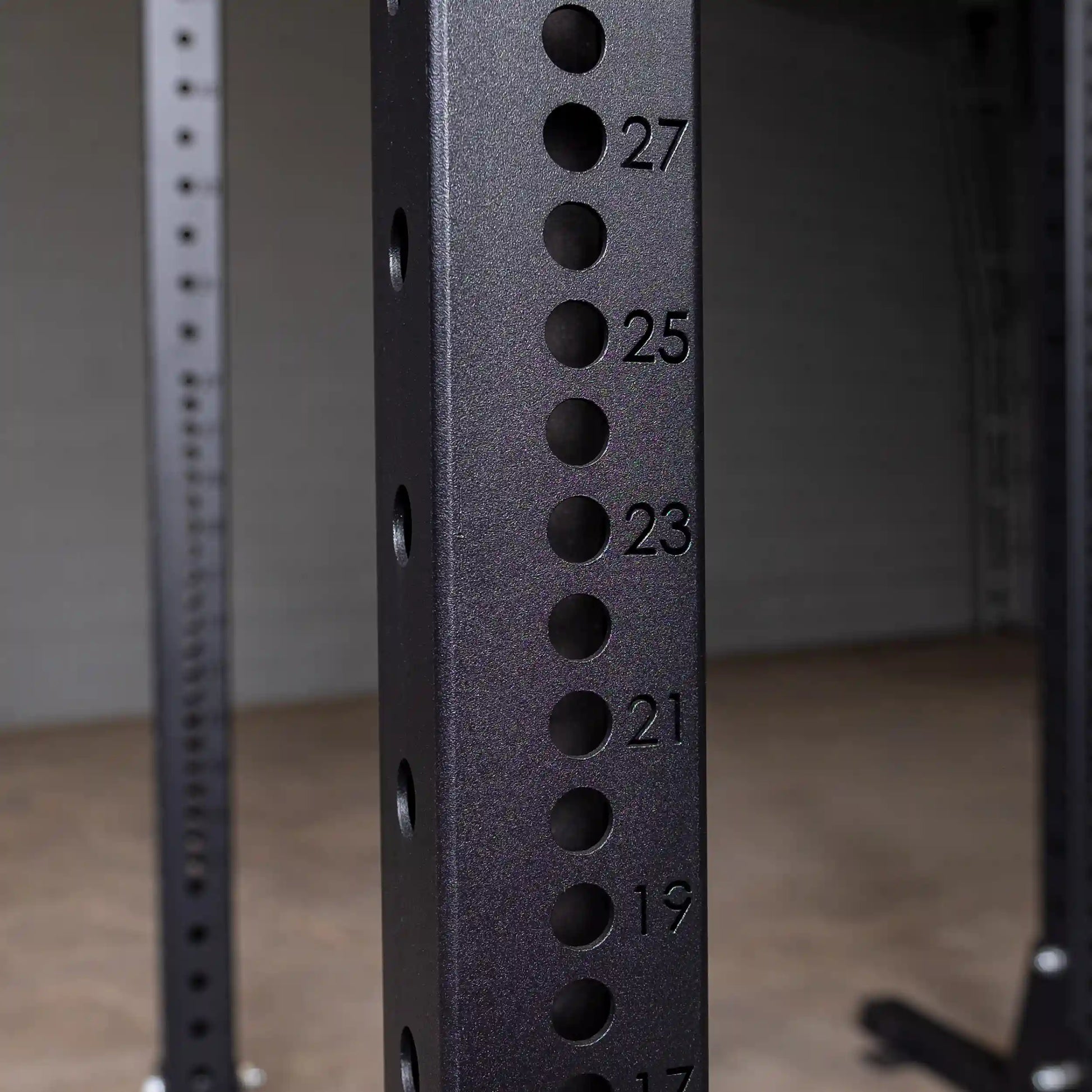 Close-up image of the Body-Solid Pro ClubLine Commercial Half Rack SPR500, showing the numbered adjustment holes on the vertical frame.