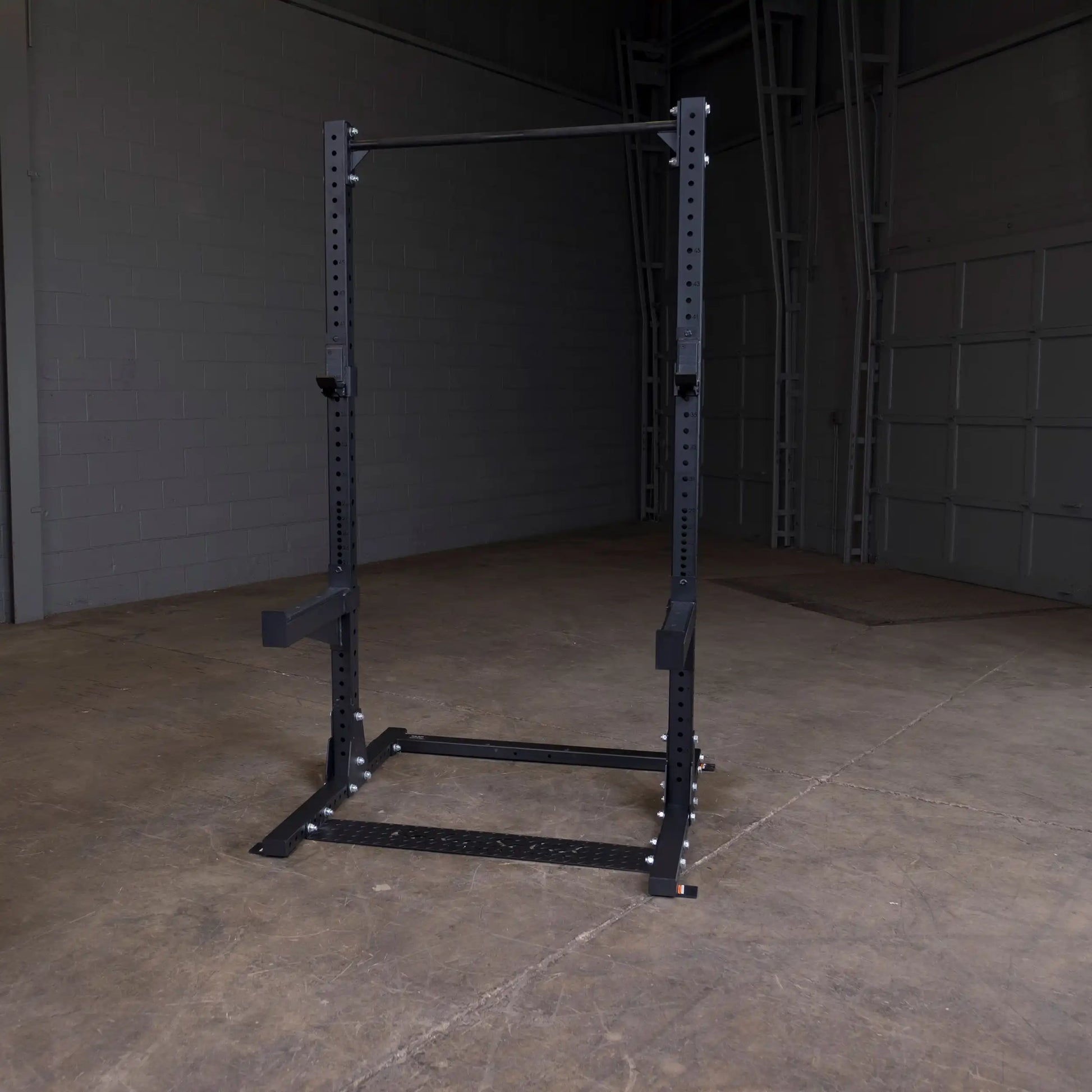 Body-Solid Pro ClubLine Commercial Half Rack SPR500 in a dimly lit industrial gym space.