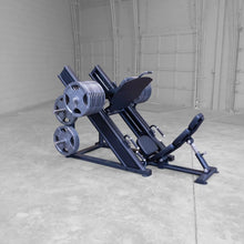 Body-Solid Pro ClubLine Commercial Leg Press Machine SGLP500 positioned in a spacious gym environment, featuring multiple weight plates and an adjustable seat.