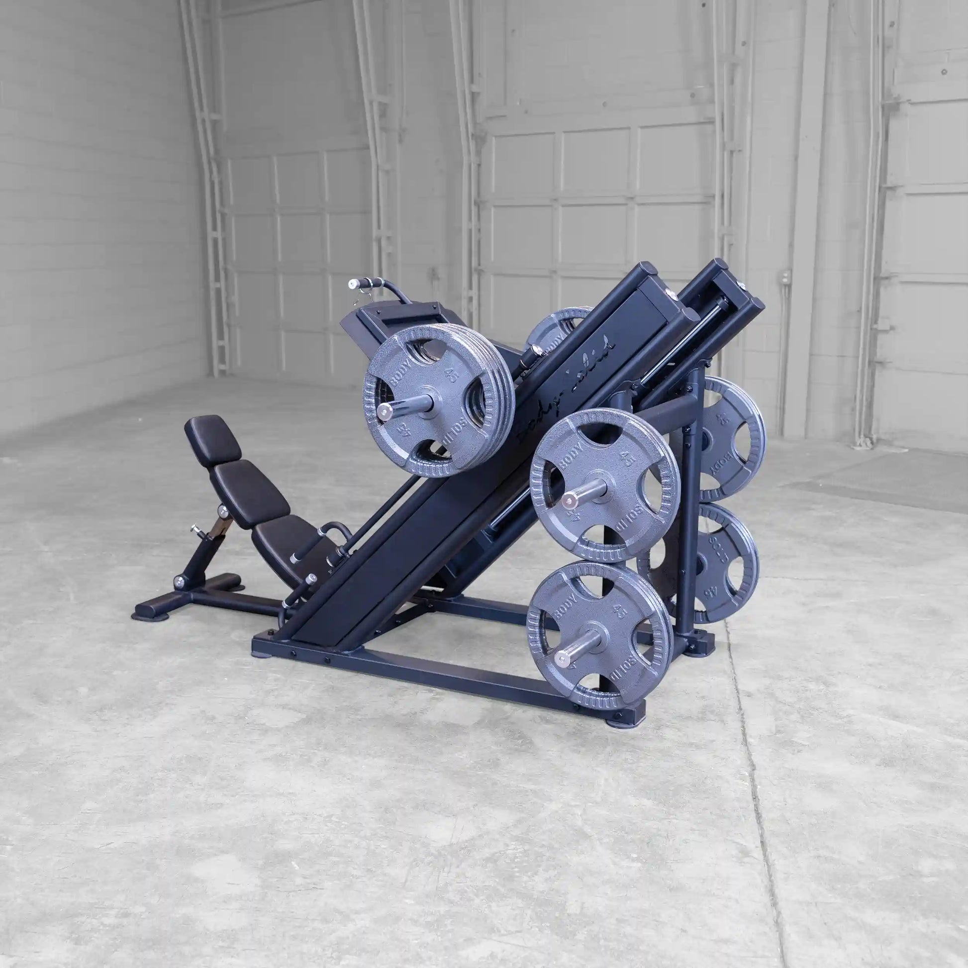 Body-Solid Pro ClubLine Commercial Leg Press Machine SGLP500 featuring adjustable seat and multiple weight plates, positioned in a spacious gym setting.