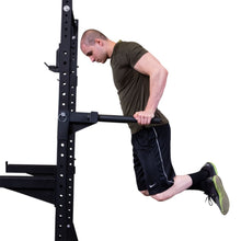 A person performing a dip exercise on the Body-Solid Pro ClubLine Dip Station Attachment SPRDIP, showcasing proper form and technique.