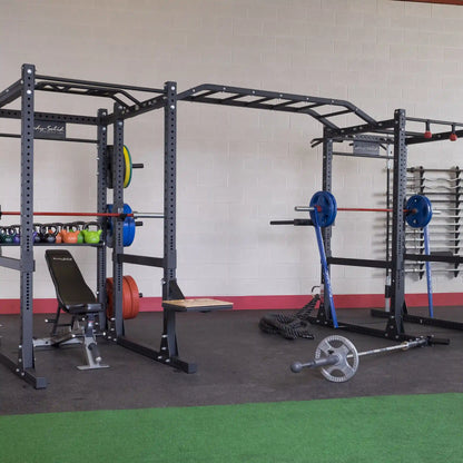 Body-Solid Pro ClubLine Double Extended Commercial Power Rack SPR1000DBBACK in a gym setting, featuring weight plates, kettlebells, and other fitness equipment.