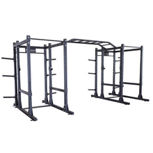 Image of the Body-Solid Pro ClubLine Double Extended Commercial Power Rack SPR1000DBBACK, featuring a sturdy steel construction with multiple bars and support structures designed for strength training and workouts.