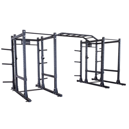 Image of the Body-Solid Pro ClubLine Double Extended Commercial Power Rack SPR1000DBBACK, featuring a sturdy steel construction with multiple bars and support structures designed for strength training and workouts.