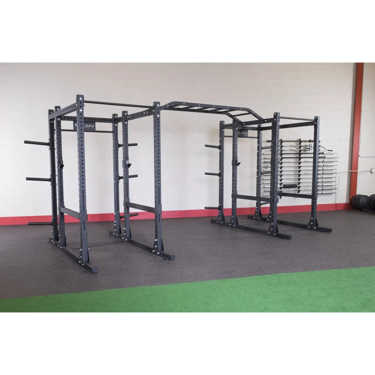 Body-Solid Pro ClubLine Double Extended Commercial Power Rack SPR1000DBBACK in a gym setting, featuring a sturdy double rack structure with multiple adjustment points and storage for weights.