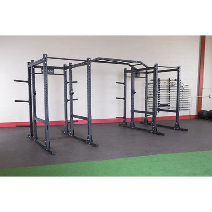 Body-Solid Pro ClubLine Double Extended Commercial Power Rack SPR1000DBBACK in a gym setting, featuring a sturdy double rack structure with multiple adjustment points and storage for weights.