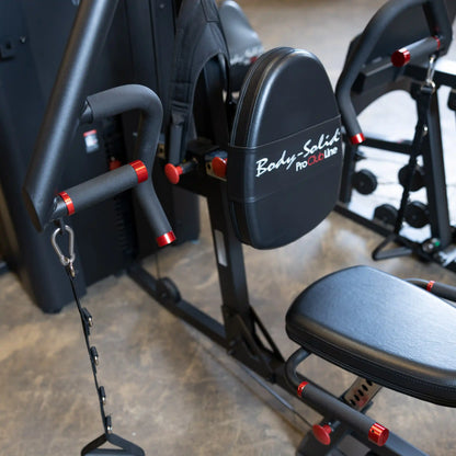 Close-up view of the Body-Solid Pro ClubLine Four-Stack Gym S1000, featuring a padded seat and adjustable handles with red accents.