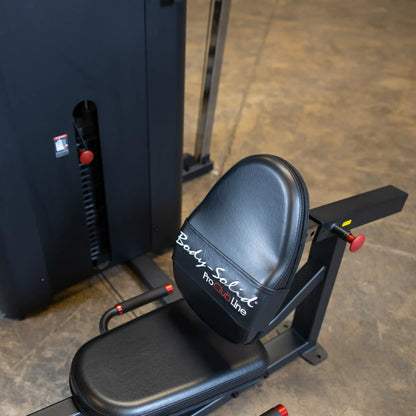 Close-up of the seat of the Body-Solid Pro ClubLine Four-Stack Gym S1000, featuring a black padded seat and the brand logo.