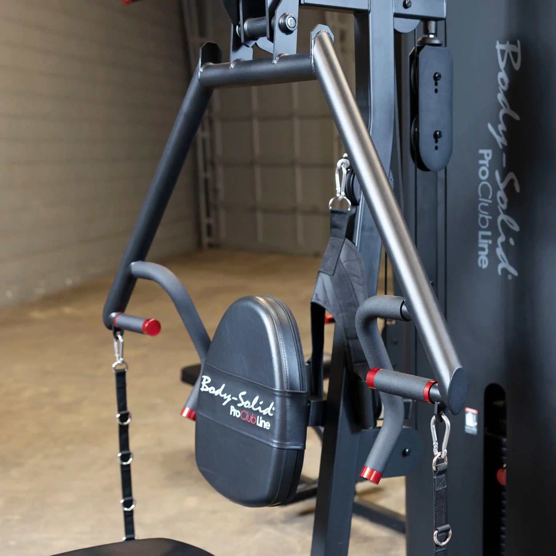 Close-up of the Body-Solid Pro ClubLine Four-Stack Gym S1000, showcasing the padded seat and handle attachments in a gym setting.