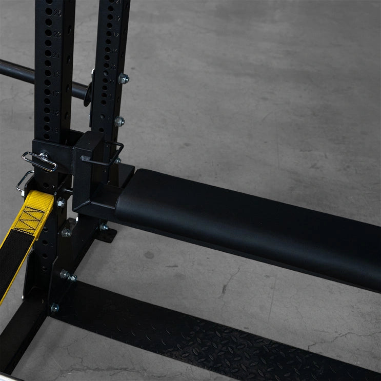 Close-up view of the Body-Solid Pro ClubLine Hip Thrust Attachment SPRHT, highlighting the padded support bar and adjustment features against a concrete floor.