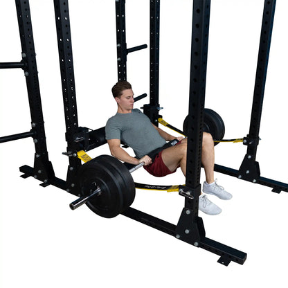 Image of a person performing a hip thrust using the Body-Solid Pro ClubLine Hip Thrust Attachment SPRHT, with a barbell loaded with weights, in a gym setting.
