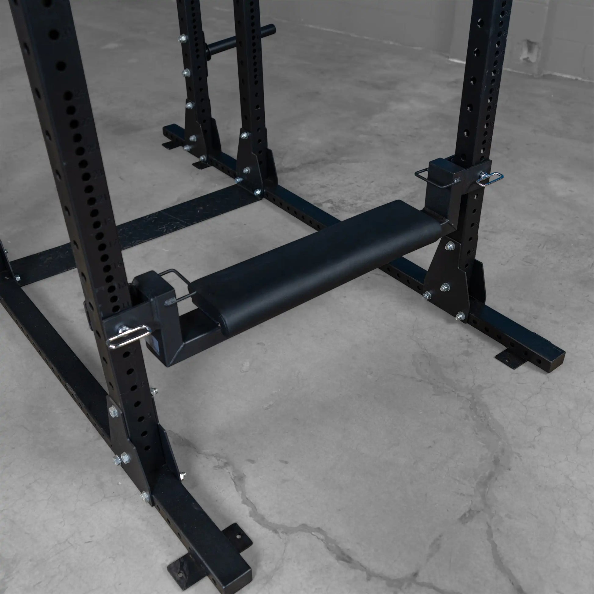 Close-up view of the Body-Solid Pro ClubLine Hip Thrust Attachment SPRHT, featuring a padded roller and sturdy metal frame, designed for effective hip thrust exercises.