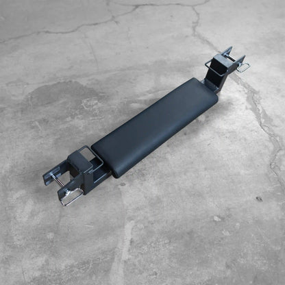 Body-Solid Pro ClubLine Hip Thrust Attachment SPRHT displayed on a concrete surface, featuring a padded black support and metal connectors for secure attachment.