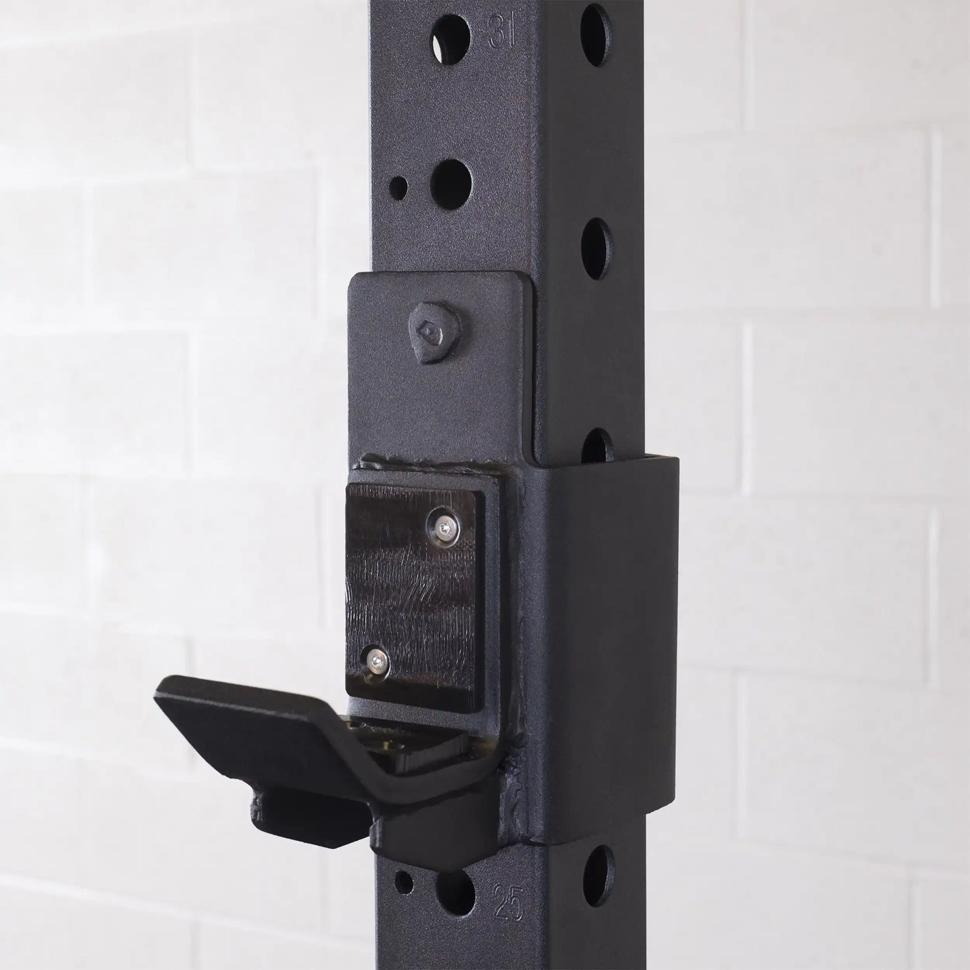Close-up of the Body-Solid Pro ClubLine J-Cups SPRJC attached to a weight rack, showcasing the sturdy design and mounting mechanism.
