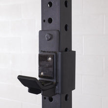 Close-up of the Body-Solid Pro ClubLine J-Cups SPRJC attached to a weight rack, showcasing the sturdy design and mounting mechanism.