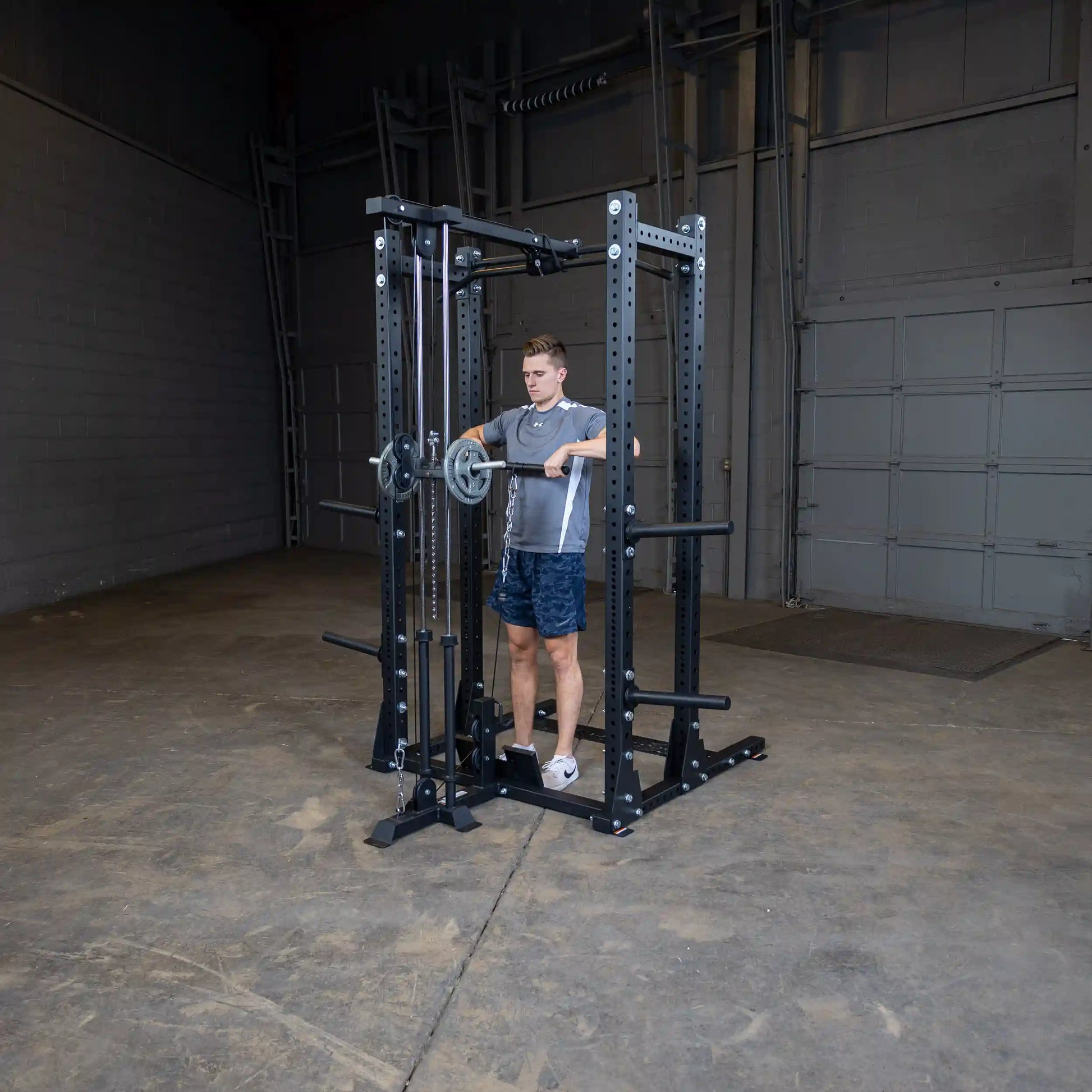 A person using the Body-Solid Pro ClubLine Lat Attachment SPRHLA in a gym setting, demonstrating a lat pull-down exercise.