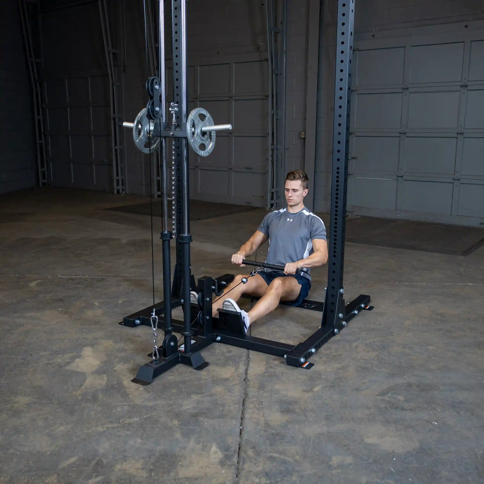 A man performing a seated row exercise using the Body-Solid Pro ClubLine Lat Attachment SPRHLA in a gym setting.