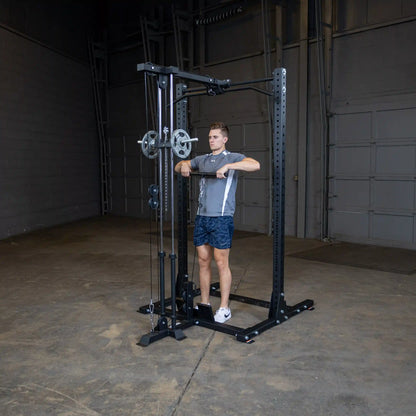 A person using the Body-Solid Pro ClubLine Lat Attachment SPRHLA in a gym setting, performing a lat pulldown exercise with weights attached to the machine.