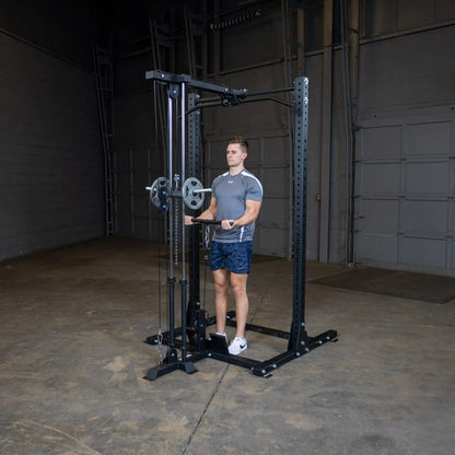 A man using the Body-Solid Pro ClubLine Lat Attachment SPRHLA in a spacious gym environment, performing an exercise with a barbell attached to the lat machine.