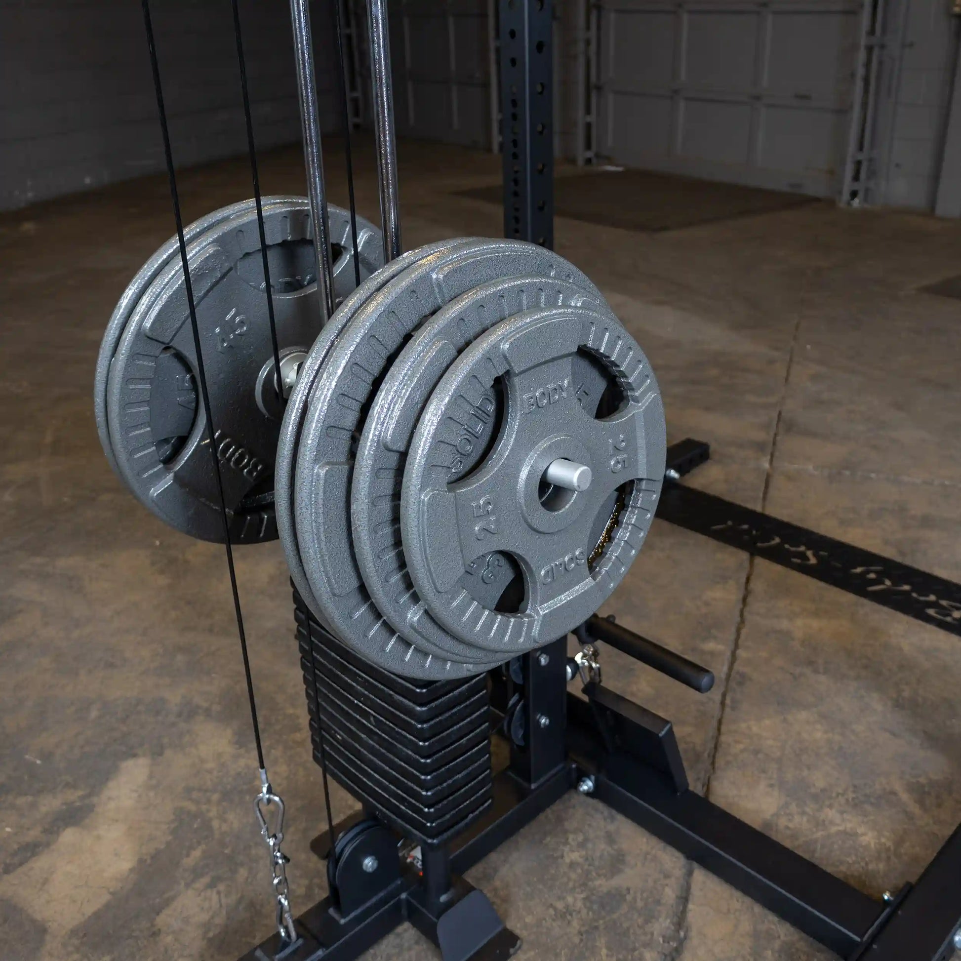 Close-up of the Body-Solid Pro ClubLine Lat Attachment SPRHLA featuring weight plates and a cable system, set against a concrete floor.