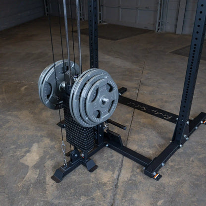 Close-up view of the Body-Solid Pro ClubLine Lat Attachment SPRHLA, featuring weight plates and cable system, set against a gym floor background.