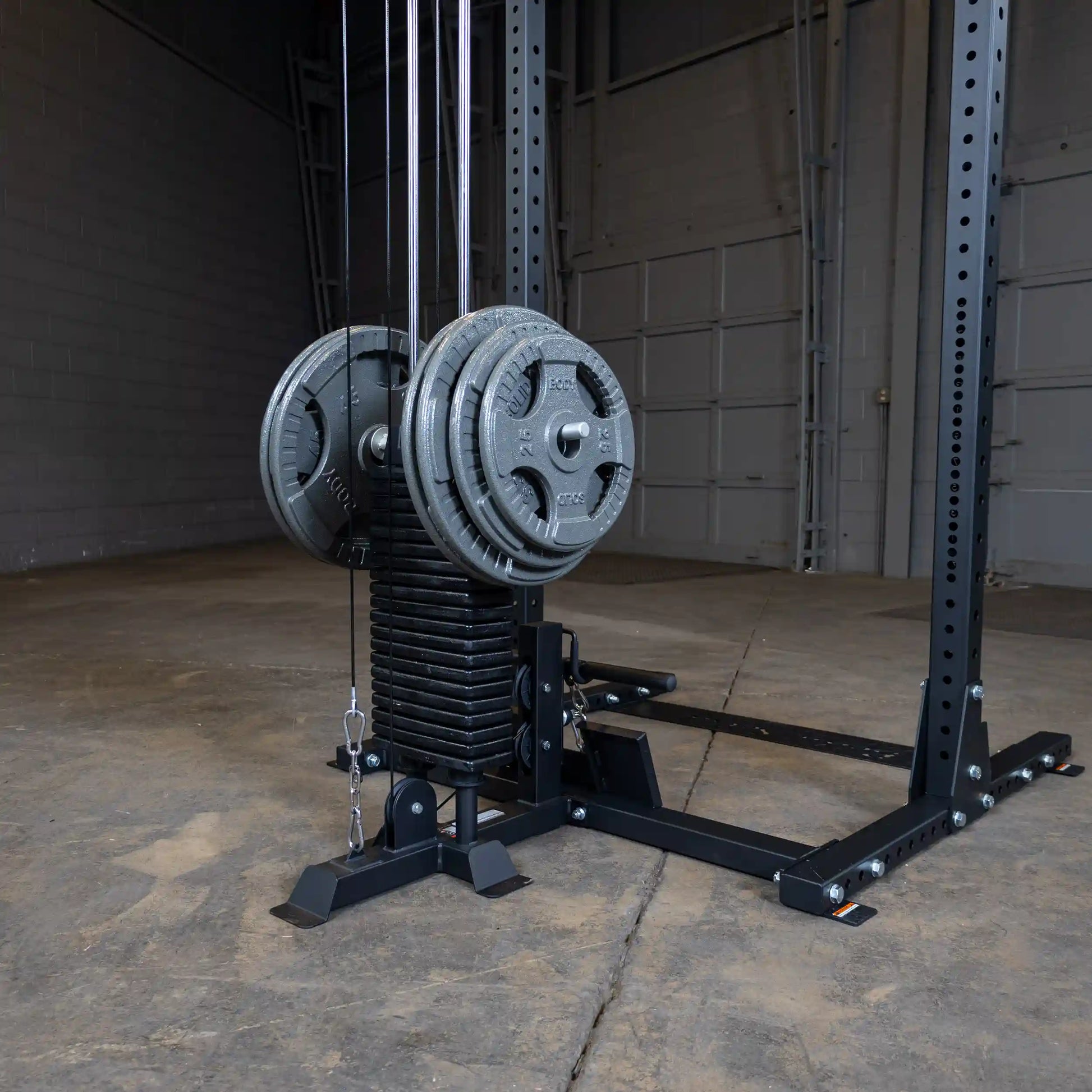 Image of the Body-Solid Pro ClubLine Lat Attachment SPRHLA, featuring a weight stack with plates and cables, set against a concrete floor in a spacious gym environment.
