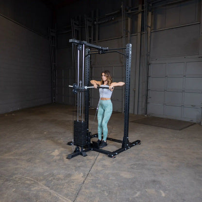 A woman using the Body-Solid Pro ClubLine Lat Attachment SPRHLA in a gym setting, performing a lat pulldown exercise.