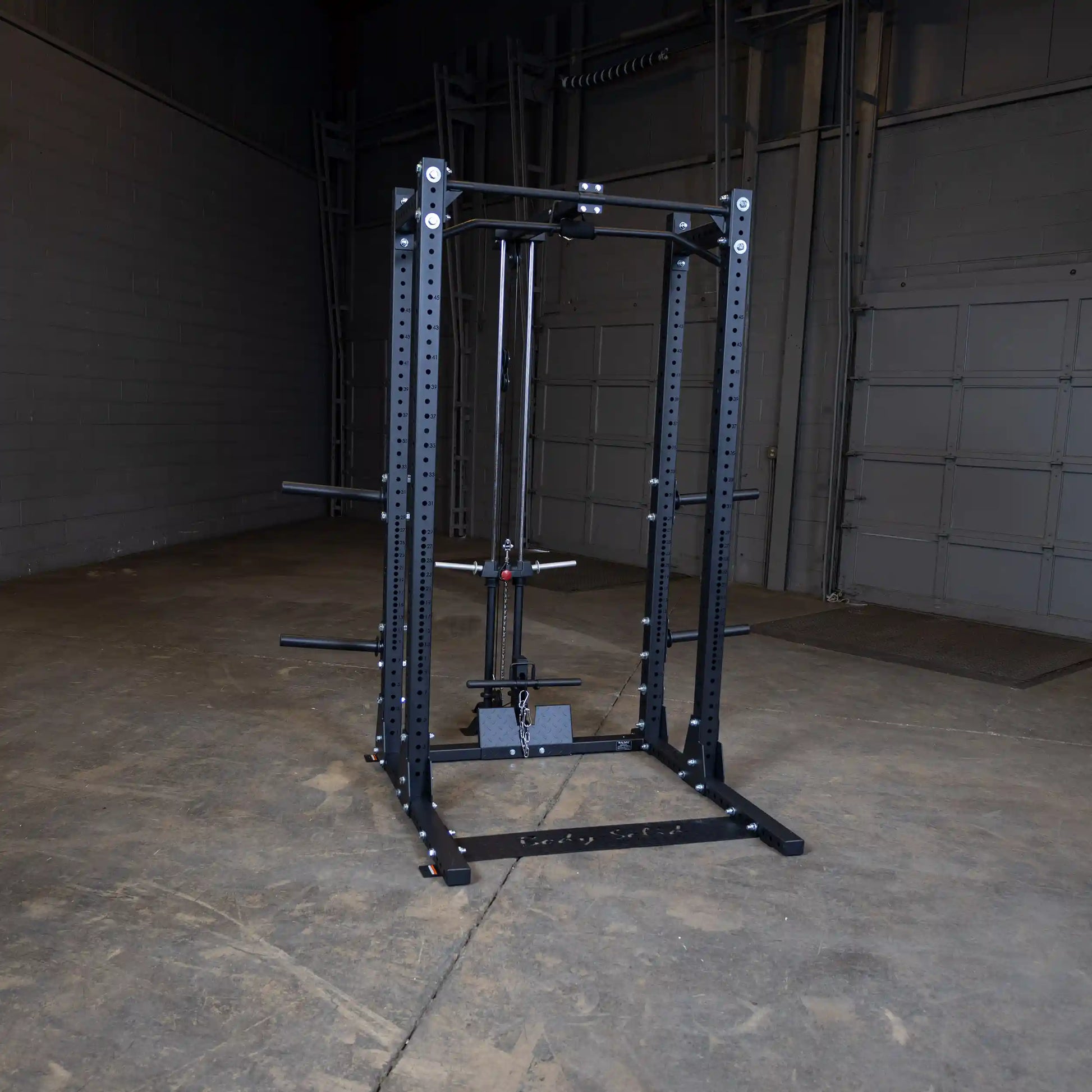 Image of the Body-Solid Pro ClubLine Lat Attachment SPRHLA, a robust piece of gym equipment designed for strength training, set in an industrial-style gym environment.