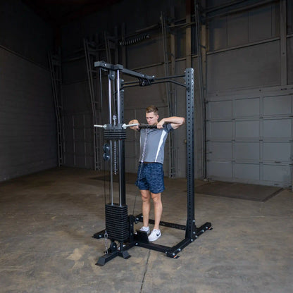 A person using the Body-Solid Pro ClubLine Lat Attachment SPRHLA in a gym setting, performing a lat pull-down exercise.