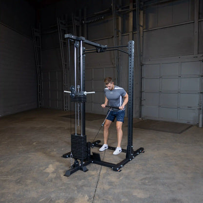 A person using the Body-Solid Pro ClubLine Lat Attachment SPRHLA in a gym setting, performing a lat pull-down exercise.