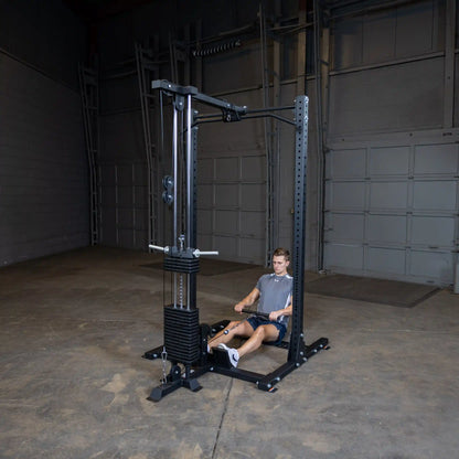 A person using the Body-Solid Pro ClubLine Lat Attachment SPRHLA for a seated rowing exercise in a spacious gym environment.