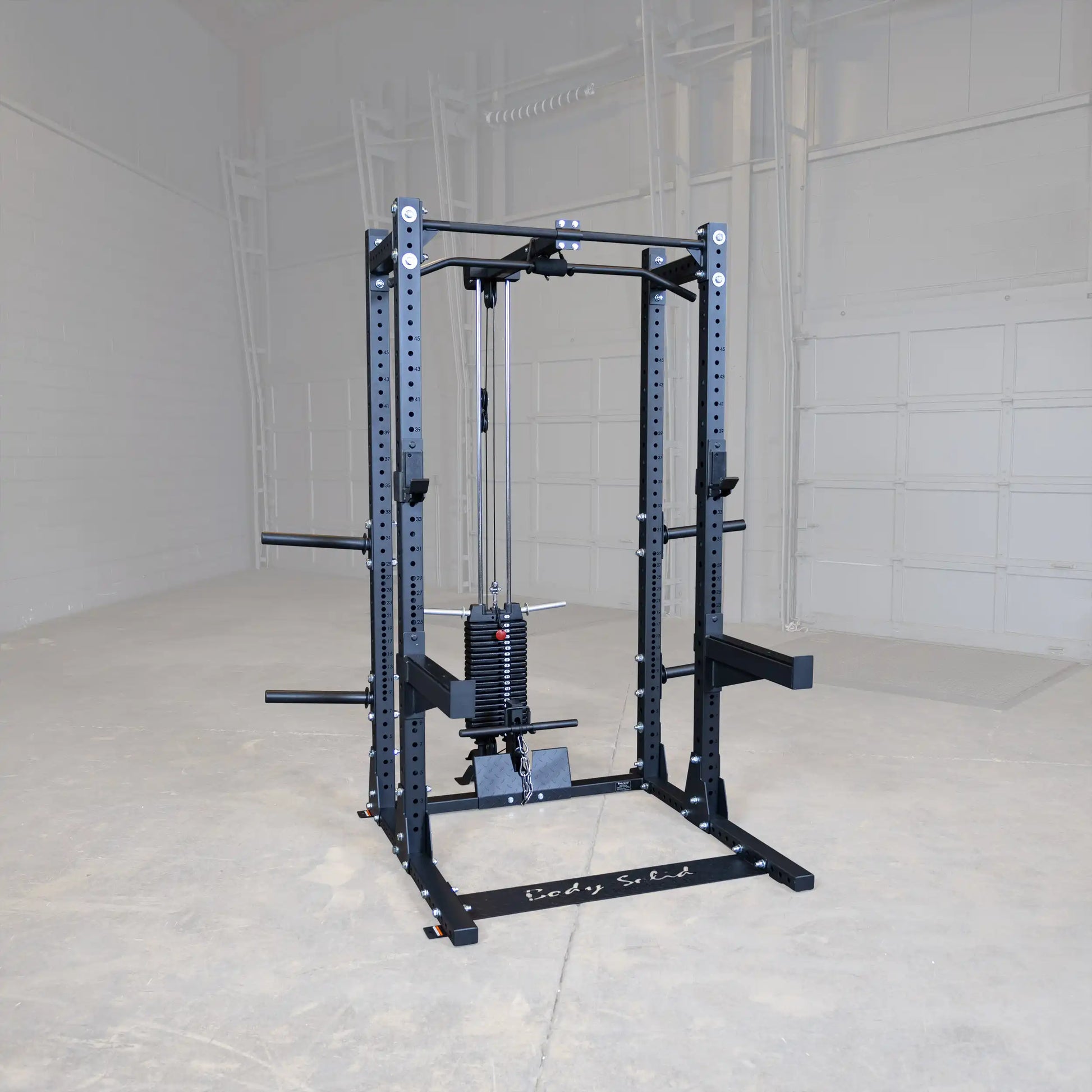 Body-Solid Pro ClubLine Lat Attachment SPRHLA mounted on a power rack in an empty gym space, featuring a weight stack and cable system for lat exercises.