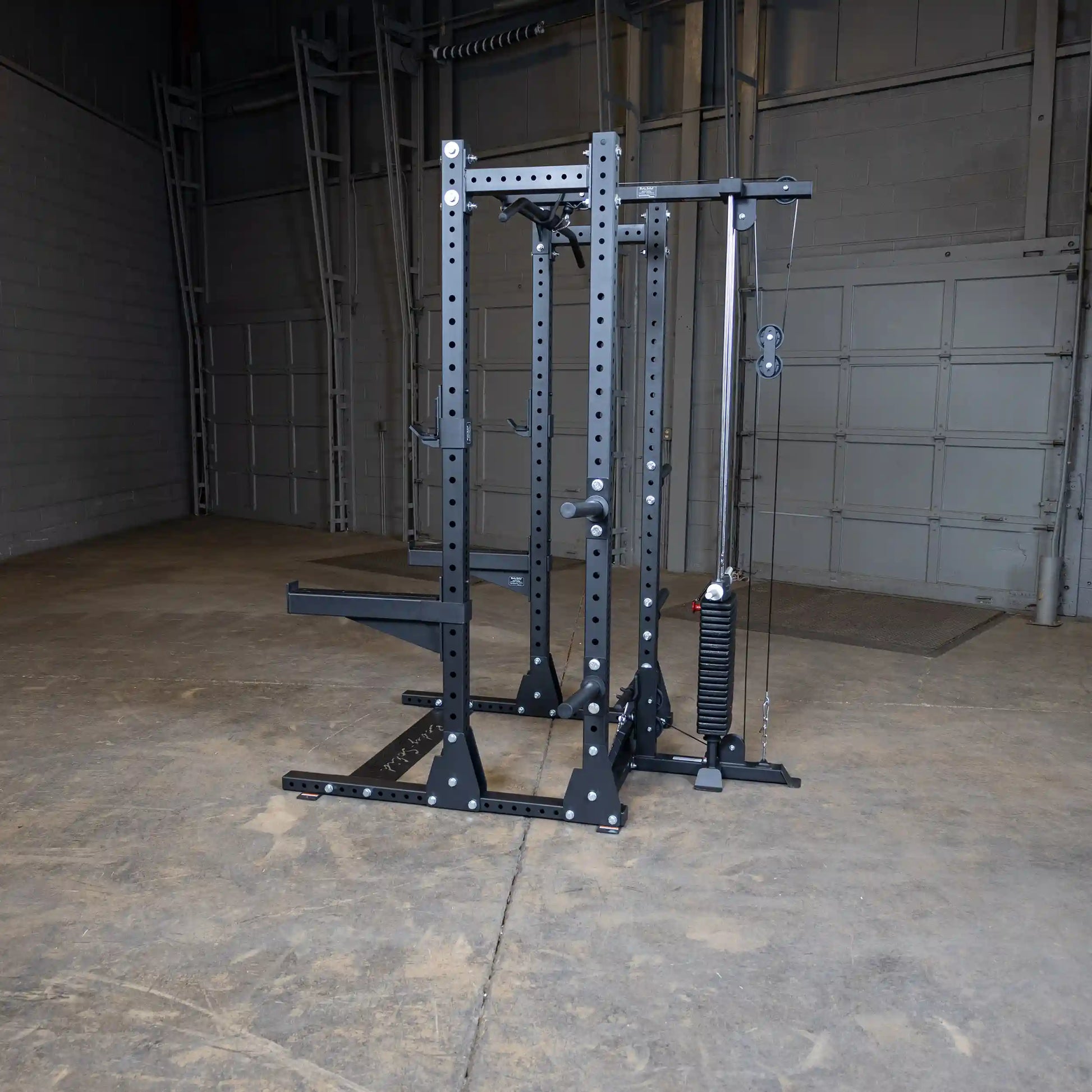 Body-Solid Pro ClubLine Lat Attachment SPRHLA positioned in a spacious gym area with concrete flooring and a gray wall backdrop.