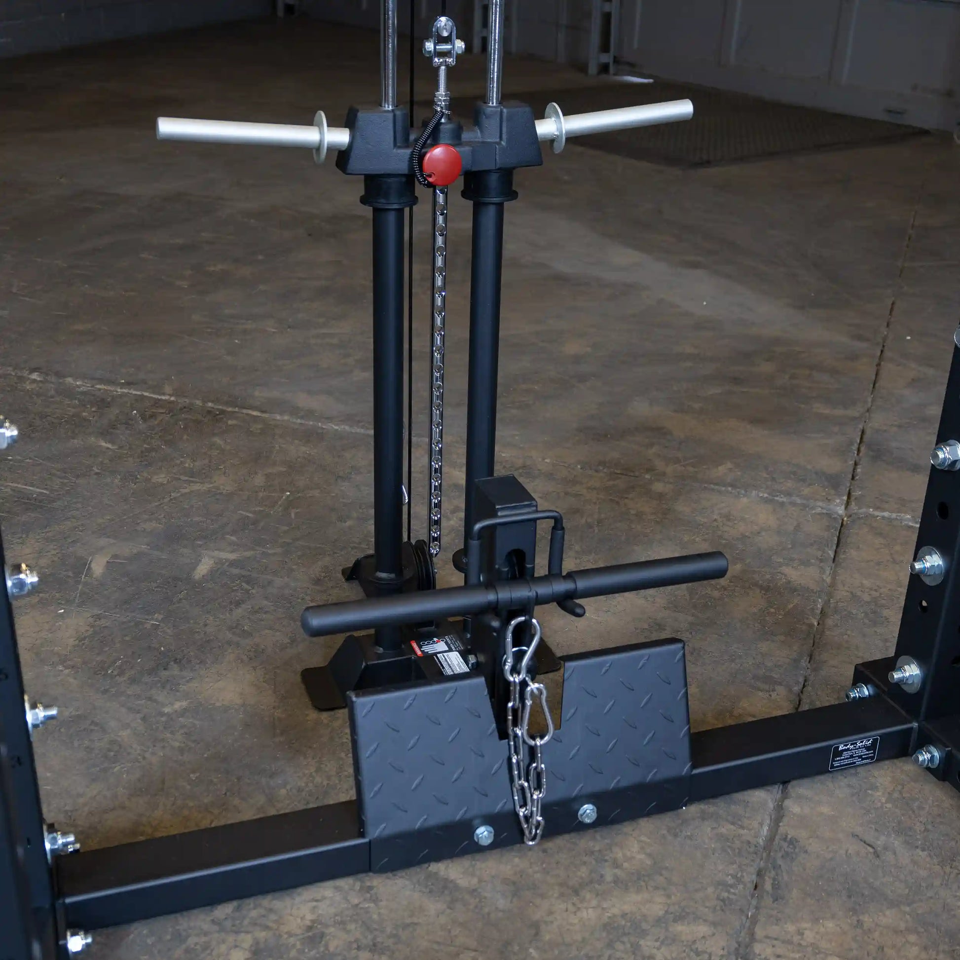 Image of the Body-Solid Pro ClubLine Lat Attachment SPRHLA, featuring dual vertical columns, a pull-down bar, and a chain mechanism on a gym floor.