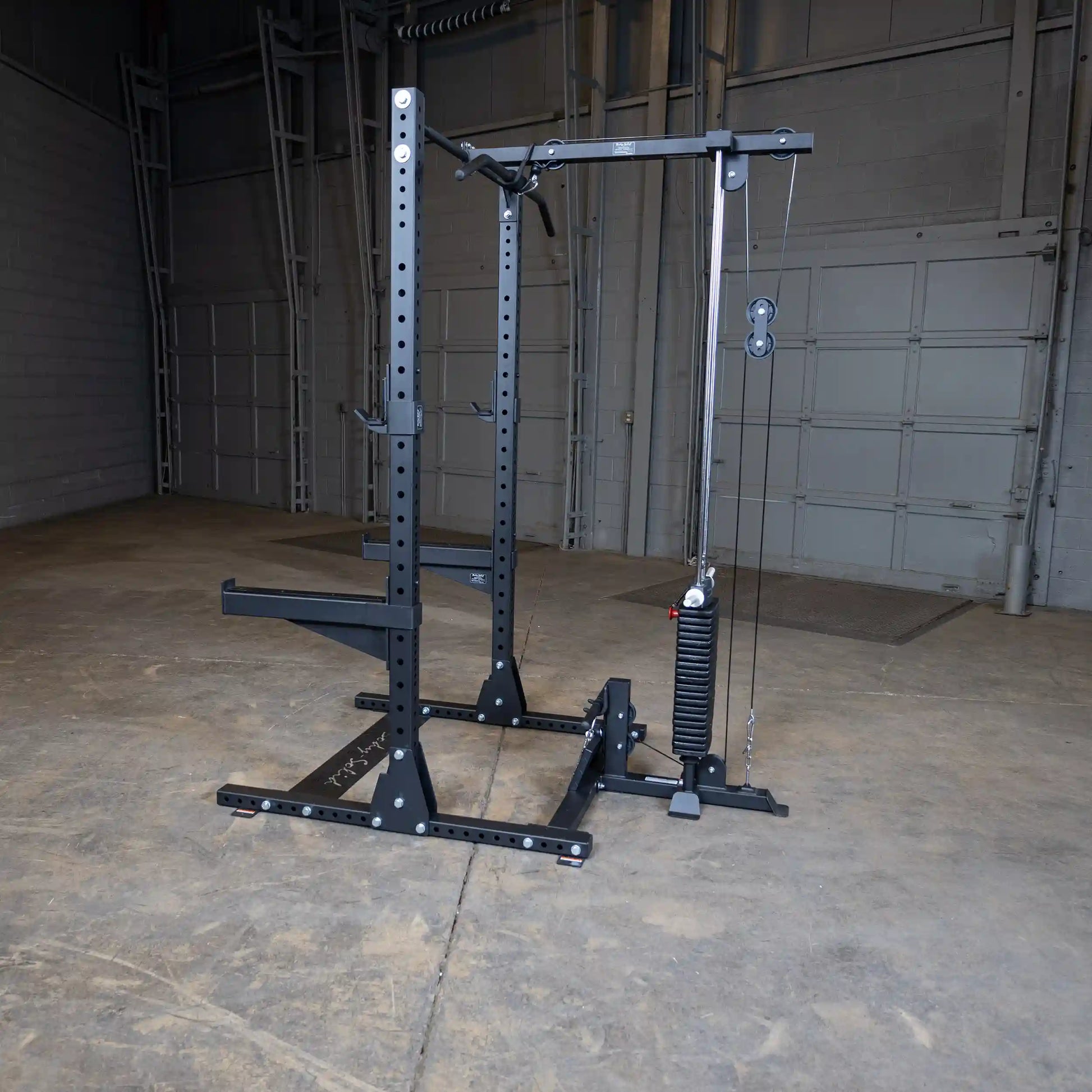 Body-Solid Pro ClubLine Lat Attachment SPRHLA displayed in an empty gym space, featuring a sturdy frame with pulleys and weight stack for strength training exercises.