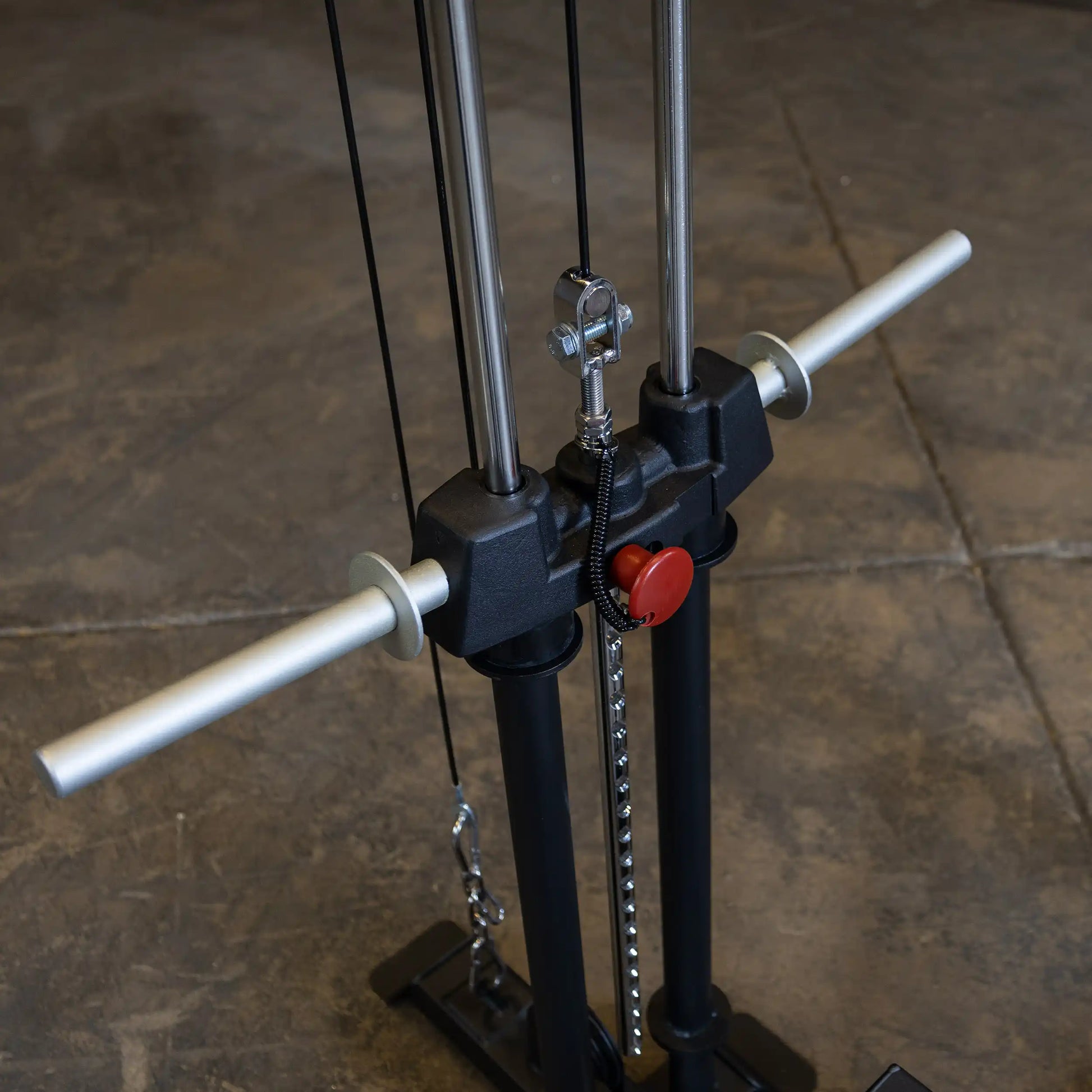Close-up view of the Body-Solid Pro ClubLine Lat Attachment SPRHLA, featuring two vertical bars, pulleys, and handles, set against a concrete floor.