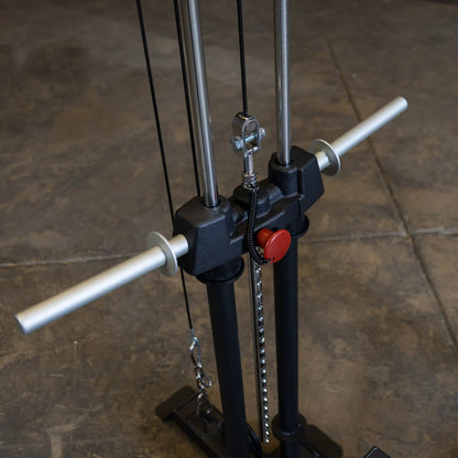 Close-up view of the Body-Solid Pro ClubLine Lat Attachment SPRHLA, featuring two vertical bars, pulleys, and handles, set against a concrete floor.