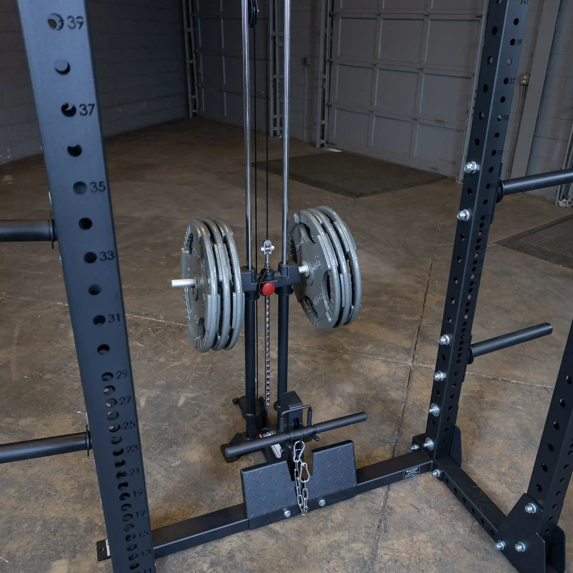 Image of the Body-Solid Pro ClubLine Lat Attachment SPRHLA featuring weight plates and a cable system, mounted on a sturdy rack in a spacious gym setting.